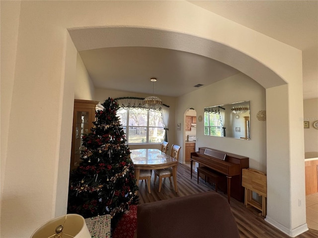 dining space with wood-type flooring