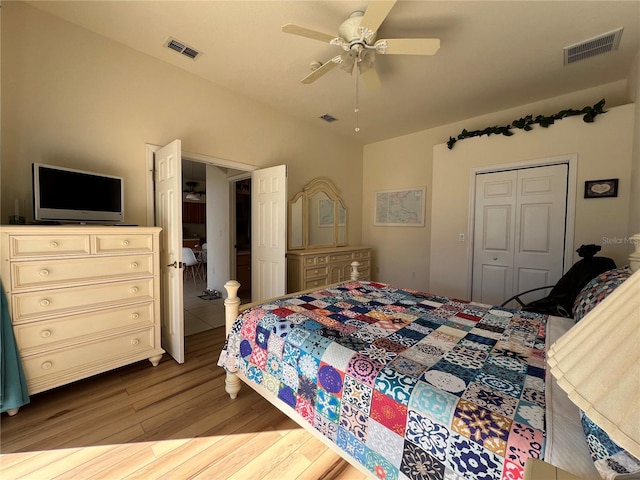 bedroom with hardwood / wood-style floors, ceiling fan, and a closet