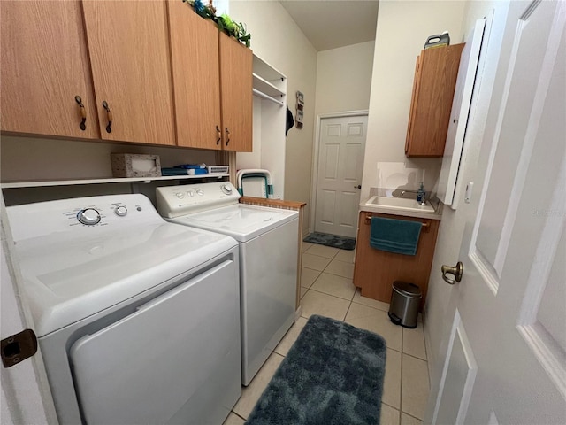 clothes washing area with cabinets, separate washer and dryer, sink, and light tile patterned floors