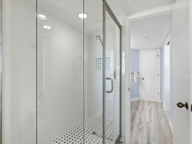 bathroom featuring an enclosed shower and hardwood / wood-style floors