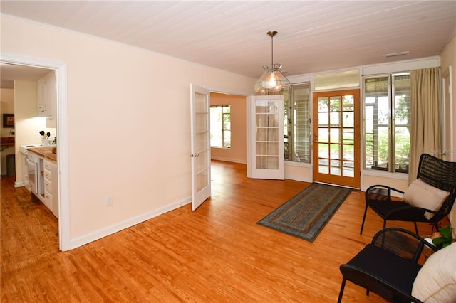 interior space with wood ceiling, light hardwood / wood-style flooring, and french doors