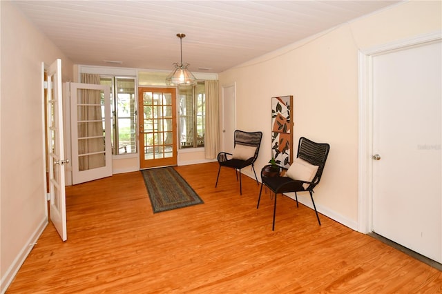 sitting room featuring light hardwood / wood-style flooring and french doors