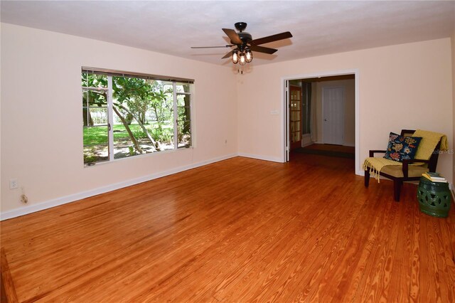 unfurnished living room featuring wood-type flooring and ceiling fan