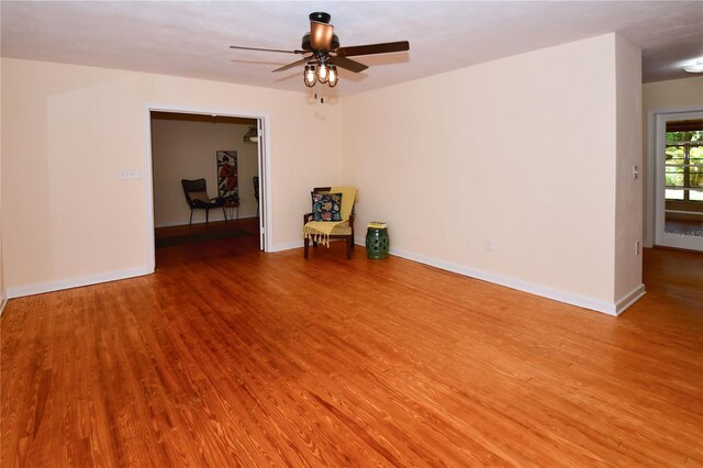 empty room featuring light wood-type flooring and ceiling fan