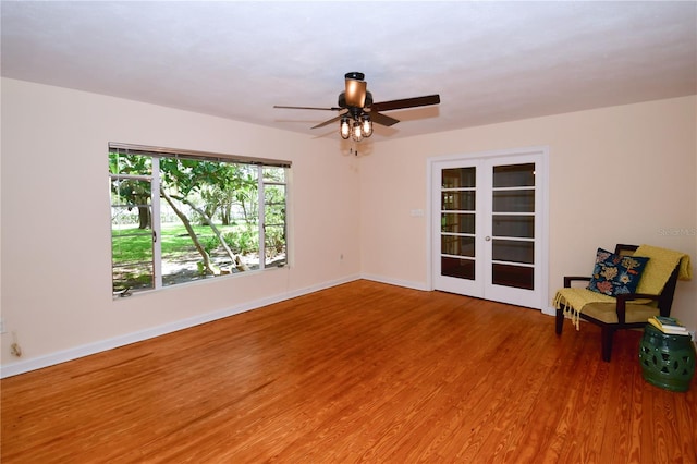 spare room featuring wood-type flooring, french doors, and ceiling fan