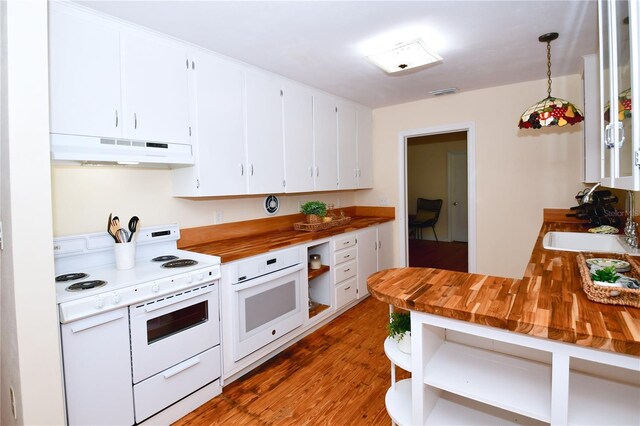 kitchen with pendant lighting, white appliances, white cabinets, dark hardwood / wood-style floors, and butcher block counters