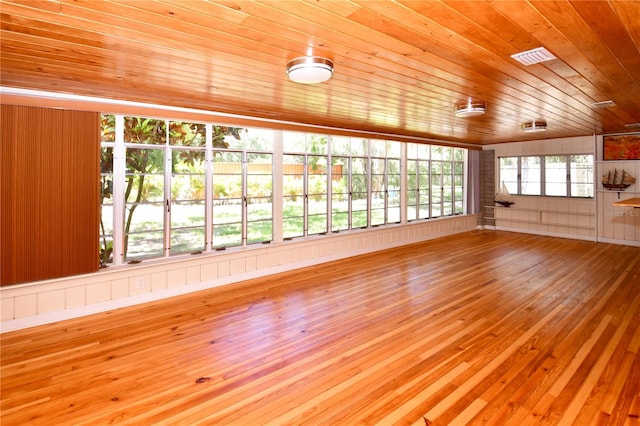 unfurnished sunroom featuring vaulted ceiling and wooden ceiling