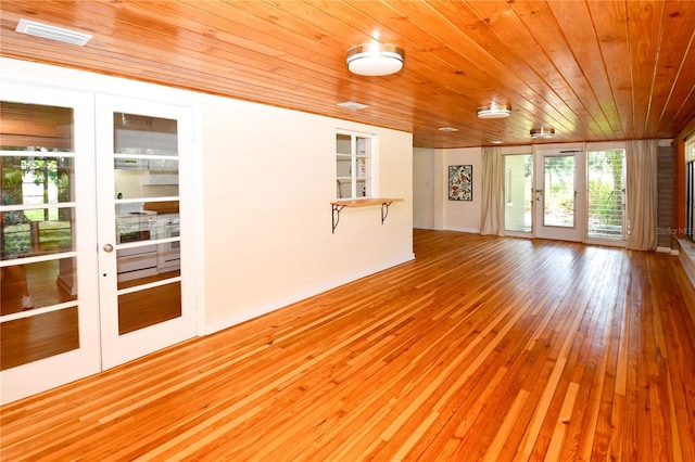 interior space featuring wood ceiling, light hardwood / wood-style flooring, and french doors