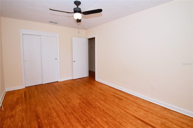 unfurnished bedroom with a closet, ceiling fan, and hardwood / wood-style floors