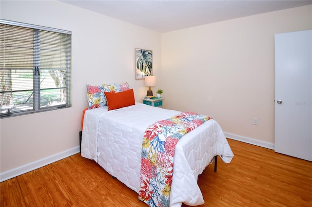 bedroom with hardwood / wood-style floors