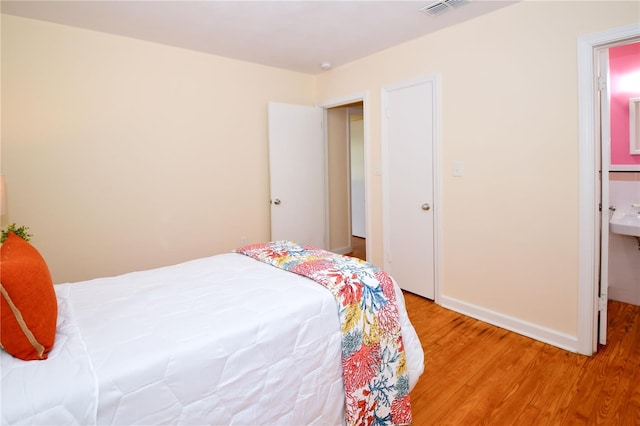 bedroom with hardwood / wood-style floors