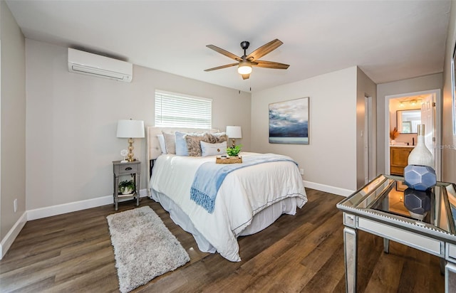 bedroom featuring ceiling fan, dark hardwood / wood-style floors, an AC wall unit, and ensuite bath