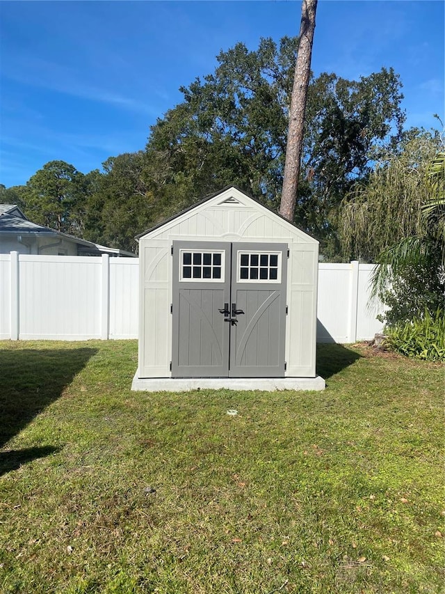 view of outbuilding with a yard