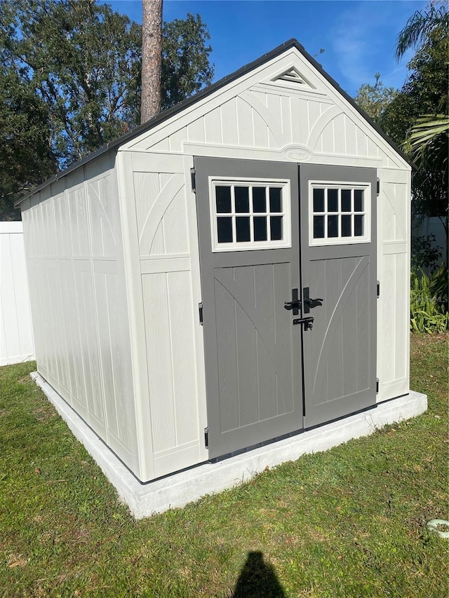 view of outbuilding with a yard