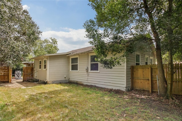 rear view of property featuring a yard