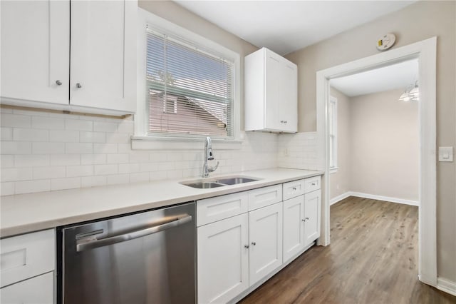 kitchen featuring sink, stainless steel dishwasher, decorative backsplash, dark hardwood / wood-style flooring, and white cabinetry