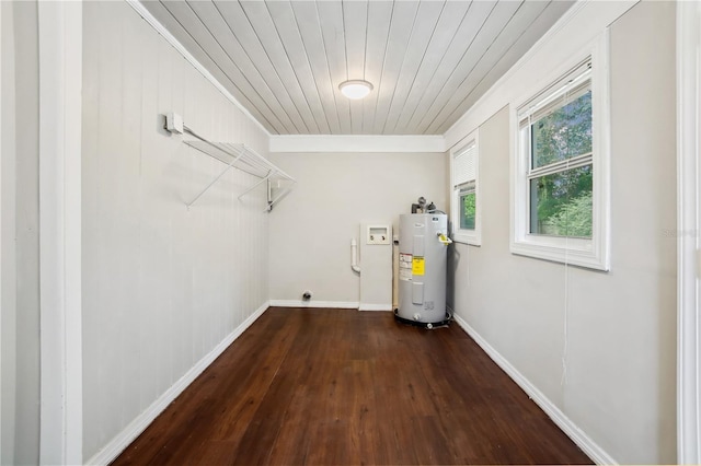 clothes washing area featuring electric water heater, dark wood-type flooring, washer hookup, ornamental molding, and wood ceiling