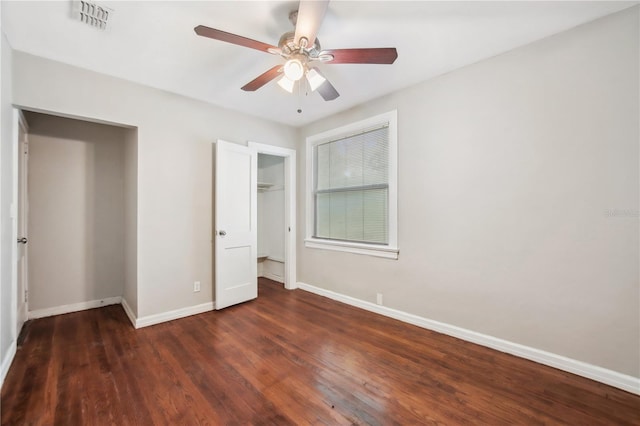 unfurnished bedroom featuring ceiling fan and dark hardwood / wood-style flooring