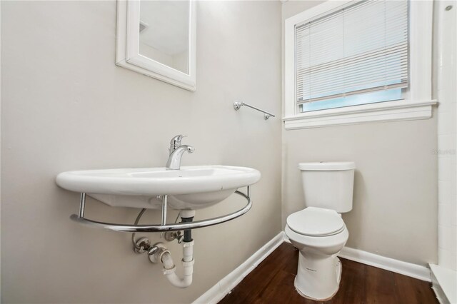 bathroom featuring hardwood / wood-style flooring and toilet