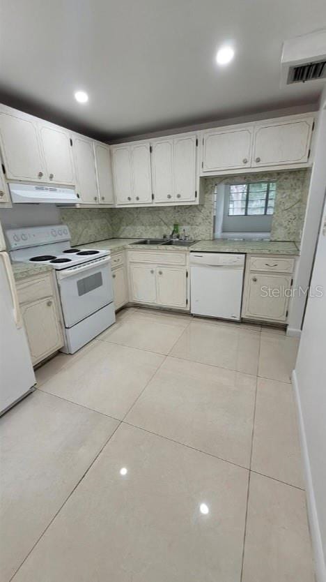 kitchen featuring white cabinets, light tile patterned floors, white appliances, and exhaust hood