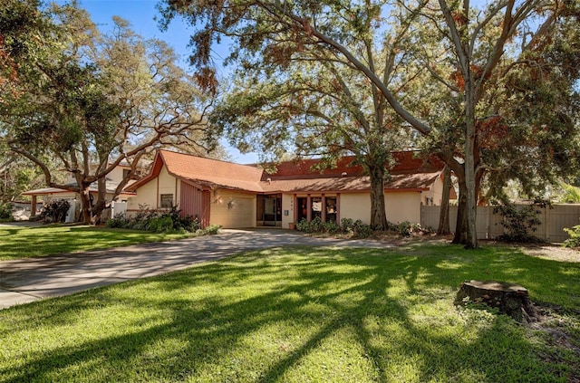 single story home with a garage and a front lawn