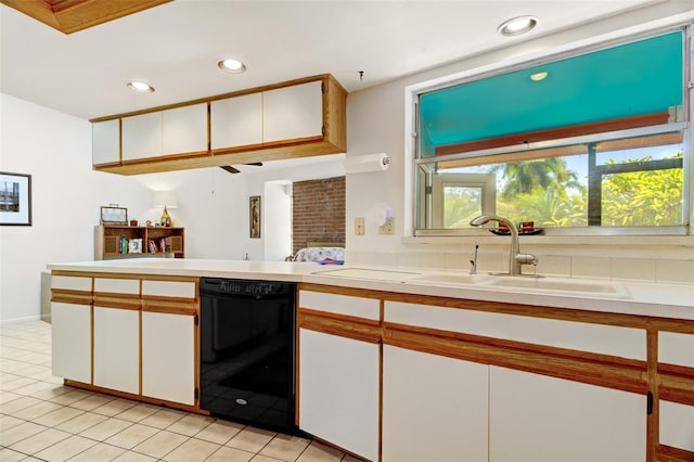 kitchen featuring dishwasher, white cabinets, light tile patterned floors, and sink