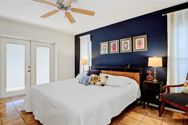 bedroom with tile patterned floors, ceiling fan, and french doors