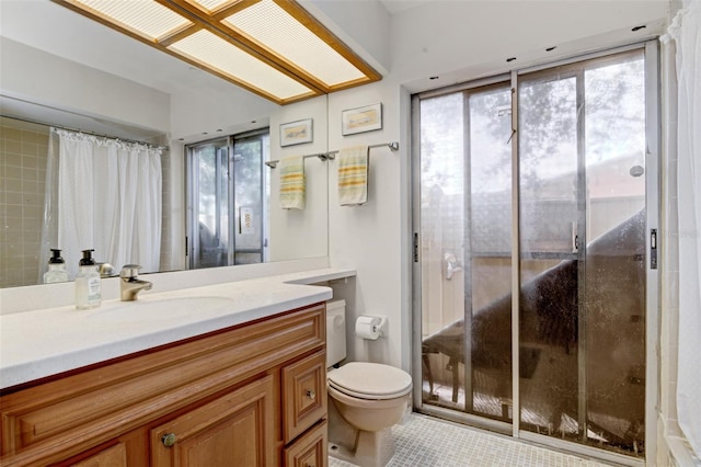 bathroom featuring tile patterned flooring, vanity, and toilet