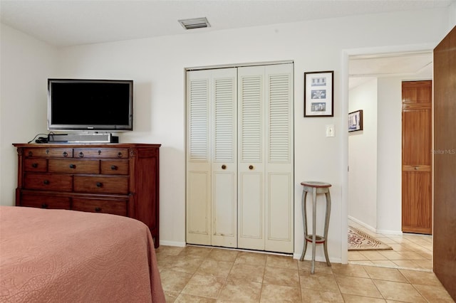 bedroom featuring light tile patterned floors and a closet