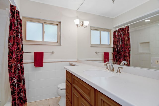 bathroom with tile patterned floors, plenty of natural light, tile walls, and toilet