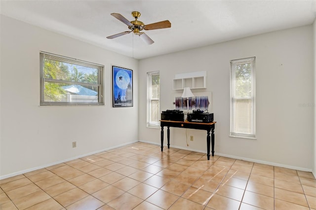 tiled home office with ceiling fan and a wealth of natural light