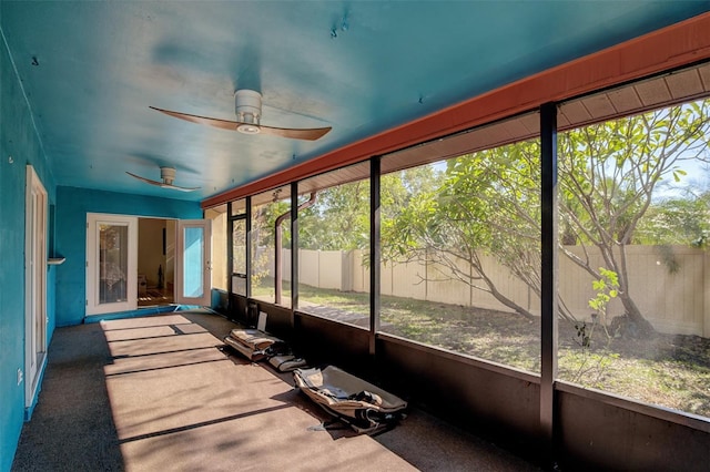 sunroom featuring ceiling fan and plenty of natural light