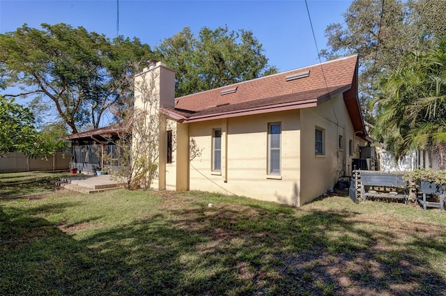 back of house with a lawn