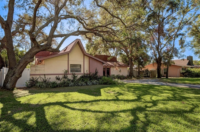 view of property exterior with a yard