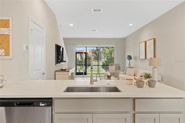 kitchen featuring dishwasher, white cabinetry, and sink