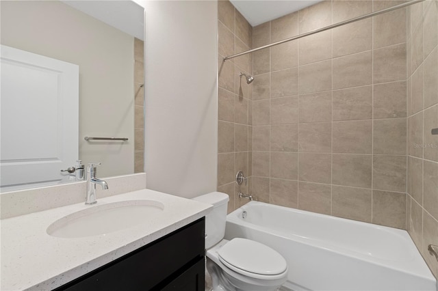 full bathroom with vanity, tiled shower / bath combo, and toilet