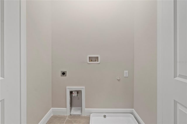 clothes washing area with electric dryer hookup, gas dryer hookup, light tile patterned flooring, and washer hookup