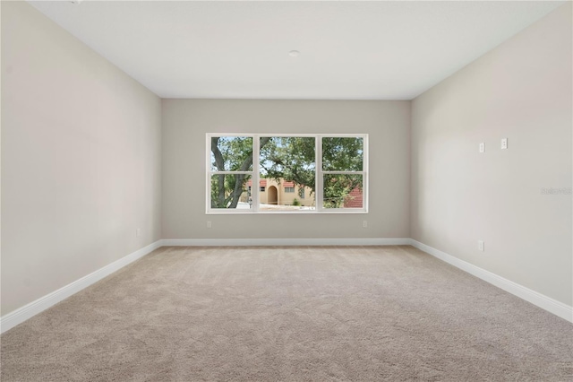 unfurnished room with light colored carpet