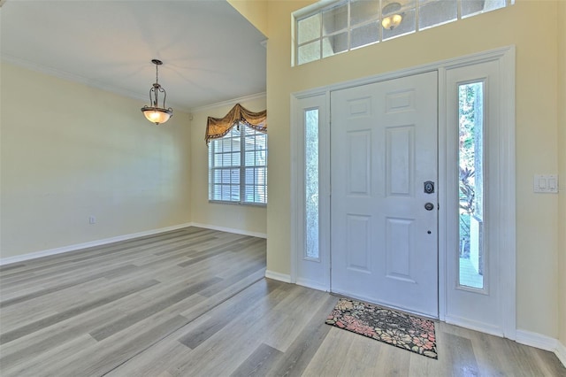 entrance foyer featuring light wood-type flooring and ornamental molding