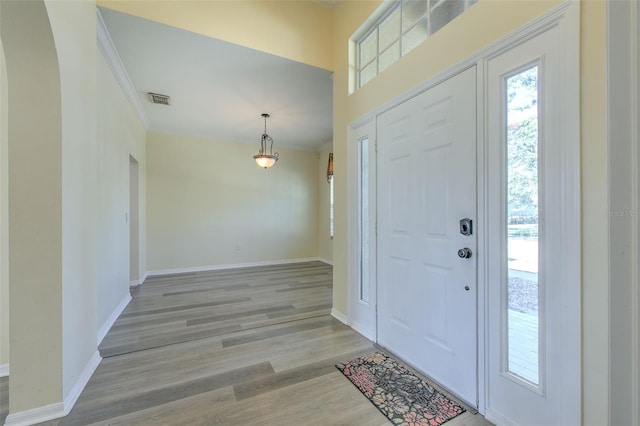 entrance foyer with light wood-type flooring and ornamental molding