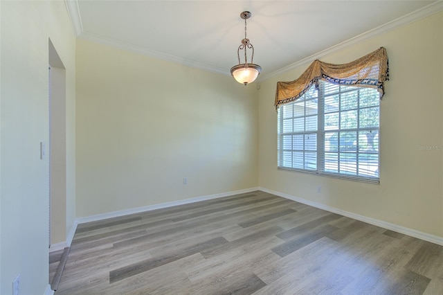 spare room with light hardwood / wood-style flooring and ornamental molding