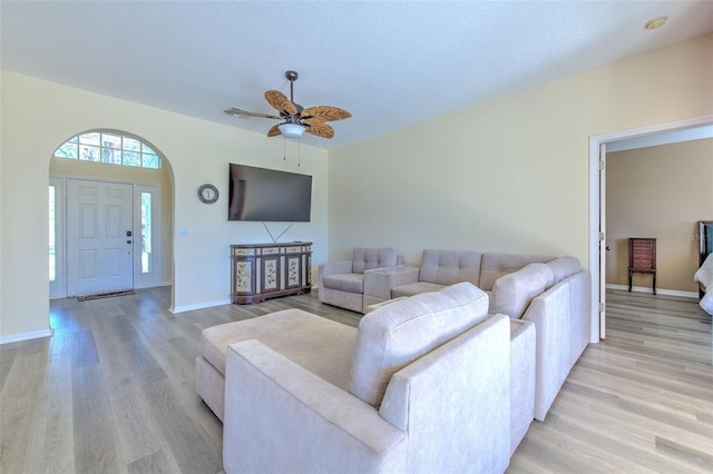 living room featuring ceiling fan and light hardwood / wood-style flooring