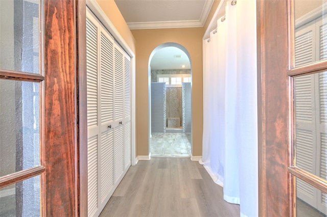 corridor featuring light hardwood / wood-style flooring and ornamental molding