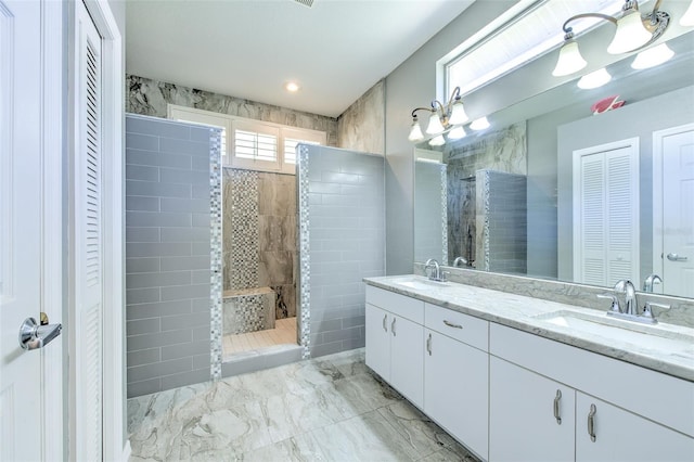 bathroom featuring vanity and tiled shower