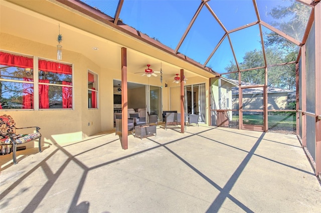 unfurnished sunroom with ceiling fan