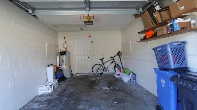 garage with a garage door opener and water heater