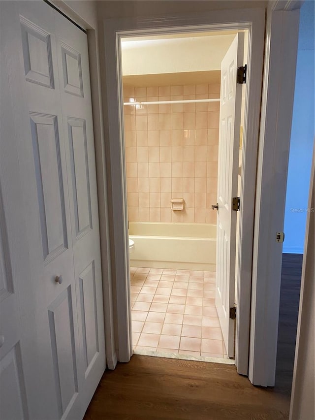 bathroom featuring hardwood / wood-style flooring and toilet