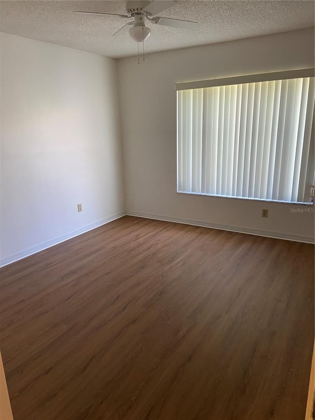 empty room featuring wood-type flooring, a textured ceiling, and ceiling fan