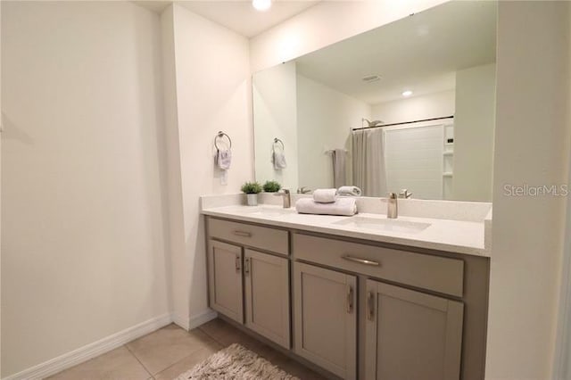 bathroom featuring tile patterned floors, vanity, and walk in shower