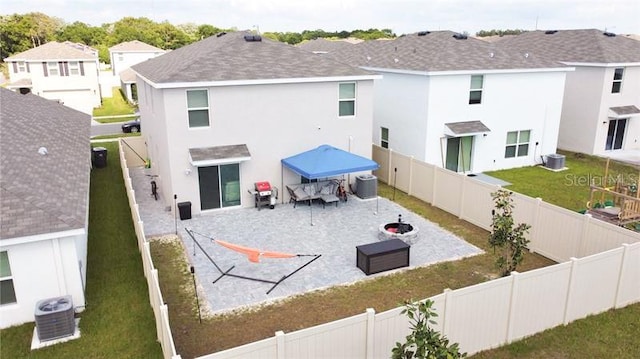 rear view of house featuring a patio and central AC